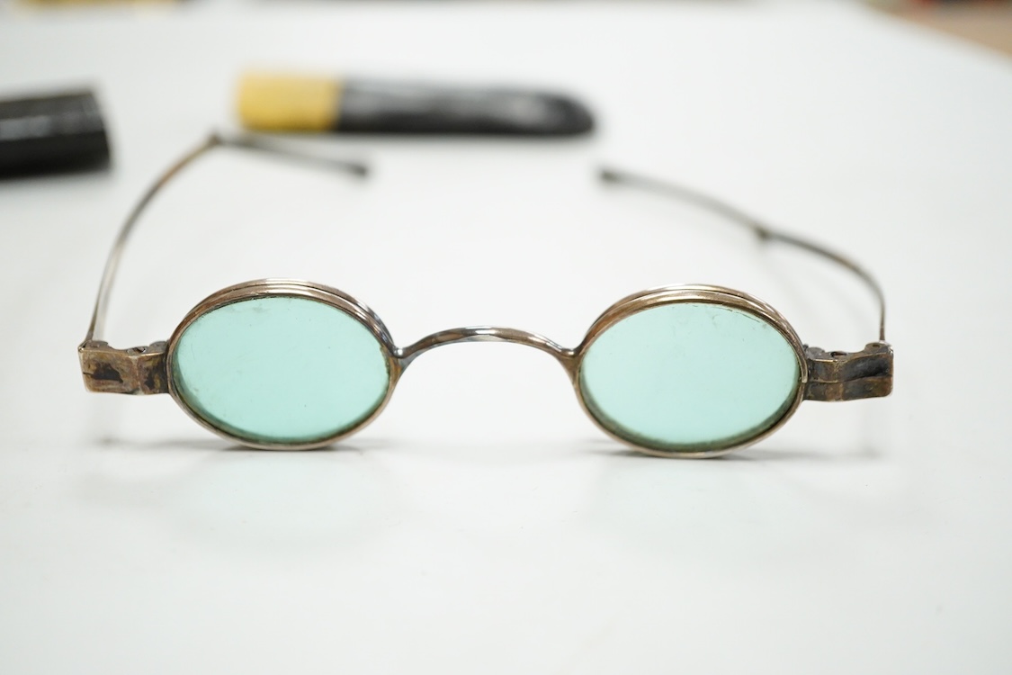 A pair of George IV silver turn pin hinged spectacles with tinted and clear double folding lenses, mm. H.I, London 1825, card case